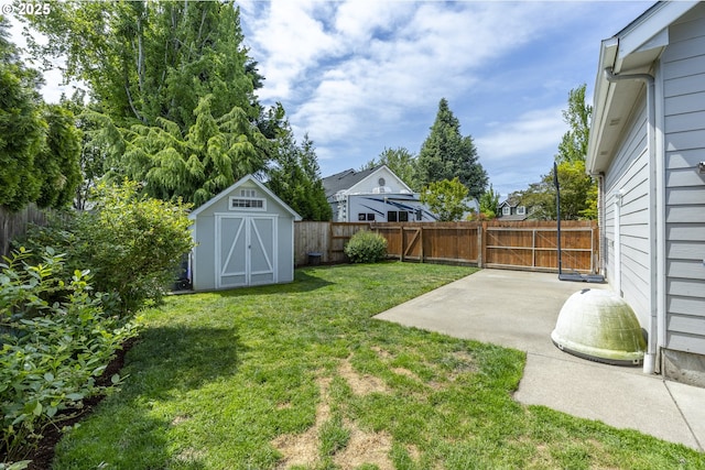 view of yard with a patio, a shed, and an outbuilding
