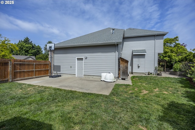 rear view of property with a patio area and a shingled roof
