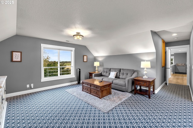 carpeted living area featuring baseboards, vaulted ceiling, a textured ceiling, and visible vents