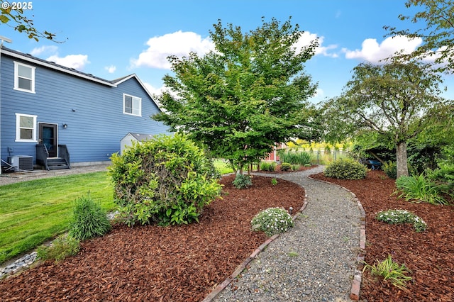 view of yard with central air condition unit and entry steps