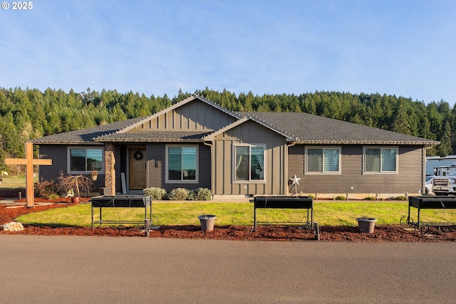 single story home featuring a view of trees, board and batten siding, and a front yard