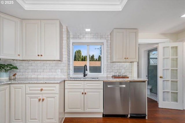 kitchen featuring a sink, dark wood-type flooring, stainless steel dishwasher, and white cabinetry