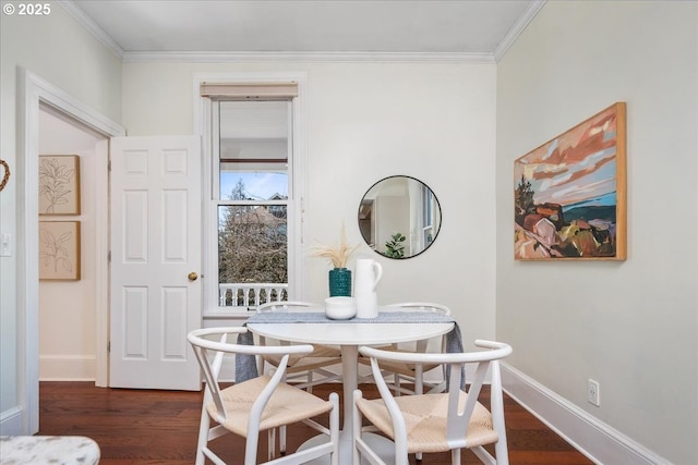 dining area featuring dark wood-style floors, baseboards, and ornamental molding