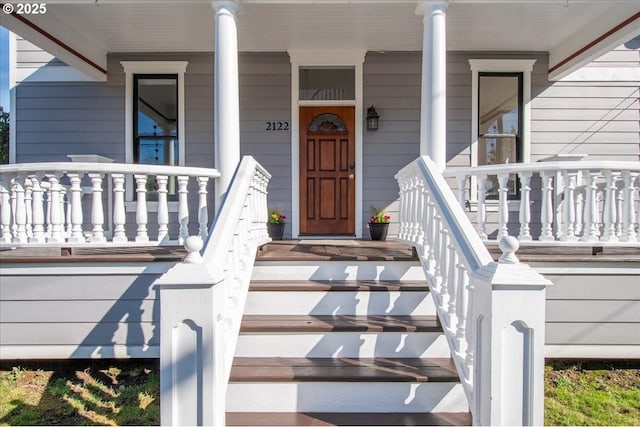 view of exterior entry with a porch