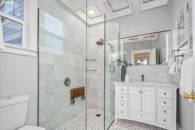 bathroom with vanity, a shower stall, and toilet