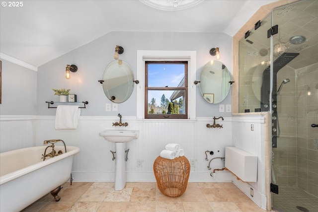 full bath featuring wainscoting, a shower stall, and vaulted ceiling