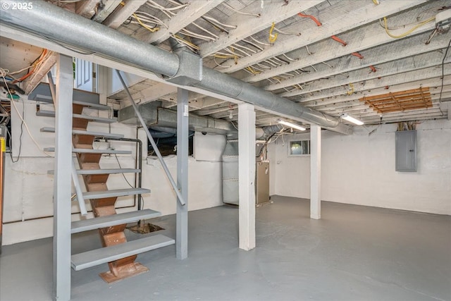 unfinished basement featuring electric panel and stairs