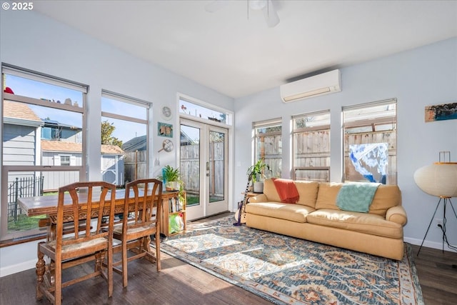 sunroom with a ceiling fan and a wall mounted AC