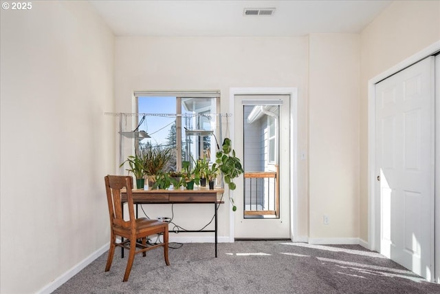 carpeted entryway featuring baseboards and visible vents