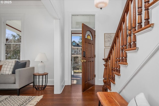 entrance foyer with stairway, baseboards, and dark wood-type flooring