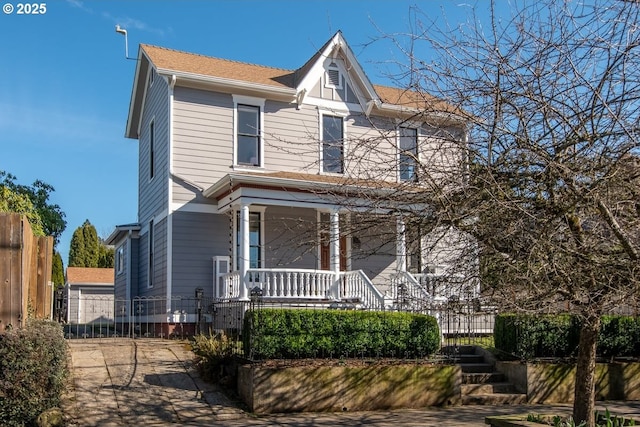 view of front of house with a porch, stairway, and fence