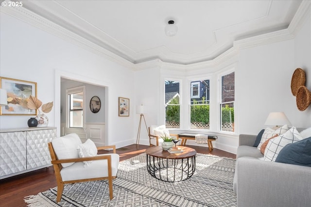 living area featuring crown molding, baseboards, and wood finished floors