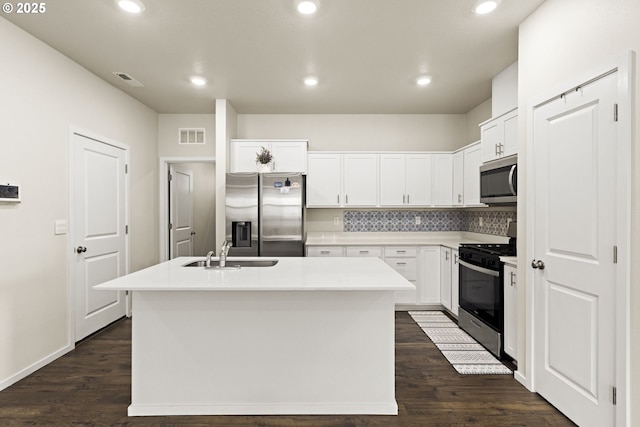 4781 Breitenbush Ave, Salem, OR 97301 - kitchen with stainless steel appliances, a center island with sink, white cabinetry, backsplash, and recessed lighting