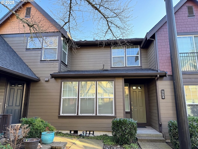 exterior space with roof with shingles