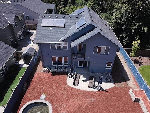 14509 SE Faircrest St, Clackamas, OR 97015 - back of house with a shingled roof, a patio, solar panels, and a fenced backyard