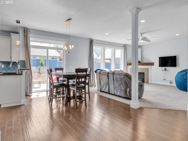 14509 SE Faircrest St, Clackamas, OR 97015 - dining space featuring plenty of natural light, a fireplace, recessed lighting, wood finished floors, and ornate columns