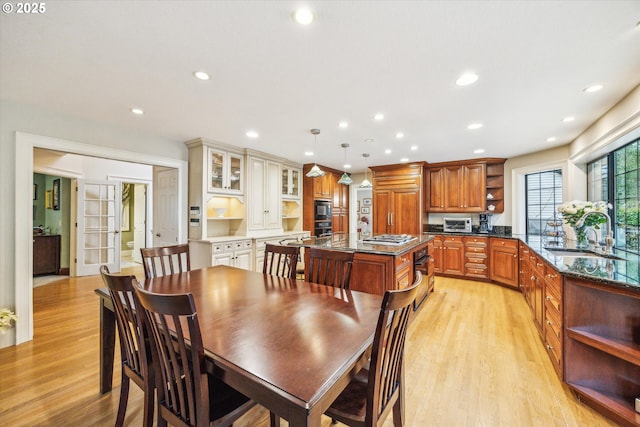 dining space featuring sink and light wood-type flooring