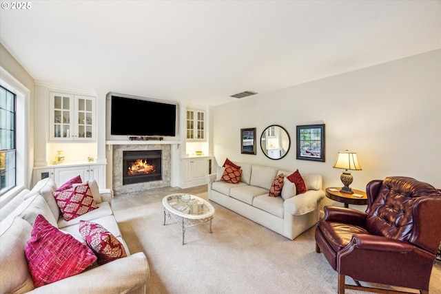 living room with light colored carpet and a fireplace