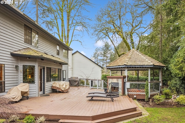 wooden terrace featuring a gazebo and grilling area