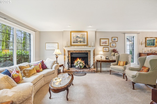 carpeted living room with a fireplace and ornamental molding