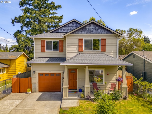9568 N Tioga Ave, Portland, OR 97203 - view of front of home with roof with shingles, an attached garage, covered porch, and concrete driveway