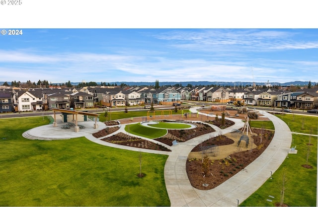 view of property's community featuring a lawn and a residential view