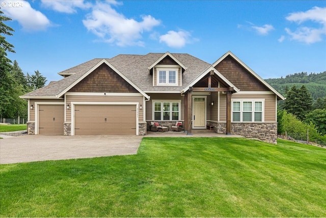 craftsman-style home with a garage and a front yard