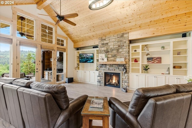 living room with a stone fireplace, high vaulted ceiling, light wood-type flooring, beamed ceiling, and ceiling fan