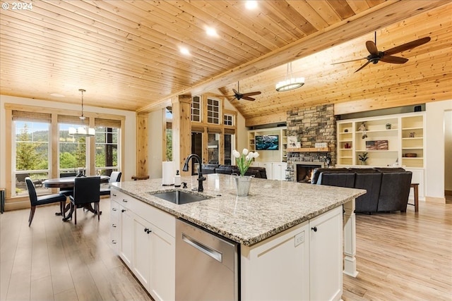 kitchen with sink, white cabinetry, hanging light fixtures, a center island with sink, and dishwasher