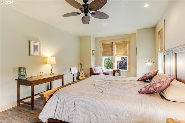 bedroom with ceiling fan and light hardwood / wood-style floors