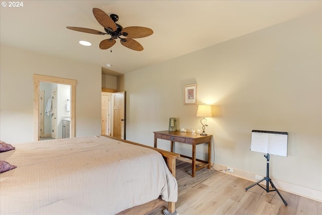 bedroom featuring ensuite bathroom, ceiling fan, and light wood-type flooring