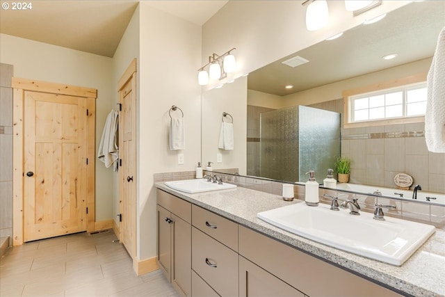 bathroom featuring vanity, a shower with shower door, and tile patterned floors