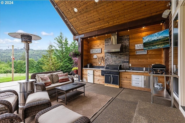 view of patio / terrace featuring an outdoor living space, a grill, and exterior kitchen