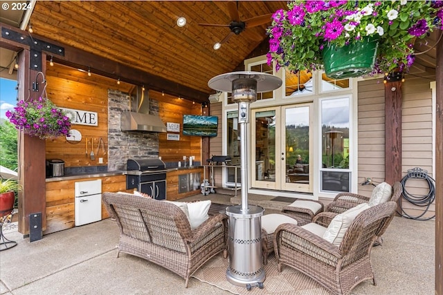 view of patio with area for grilling, french doors, ceiling fan, and exterior kitchen