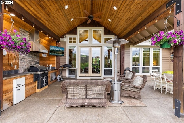 view of patio / terrace with a grill, french doors, ceiling fan, and an outdoor kitchen