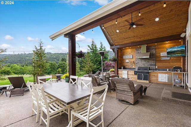 view of patio featuring an outdoor kitchen, ceiling fan, and a grill