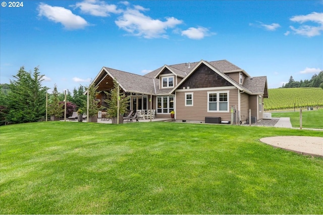 rear view of house with a lawn and a patio area