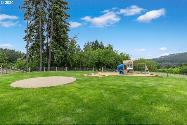 view of playground with a lawn