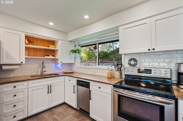 kitchen with decorative backsplash, appliances with stainless steel finishes, open shelves, a sink, and white cabinetry