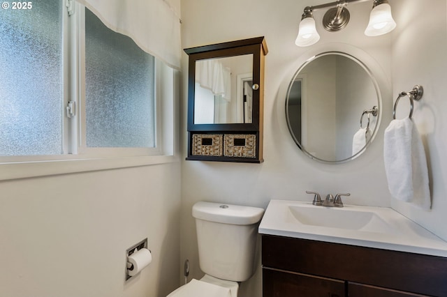 bathroom featuring toilet and vanity