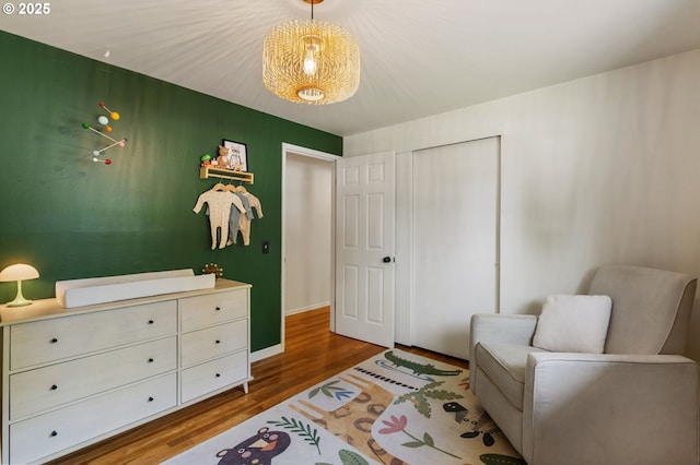 living area with baseboards and wood finished floors
