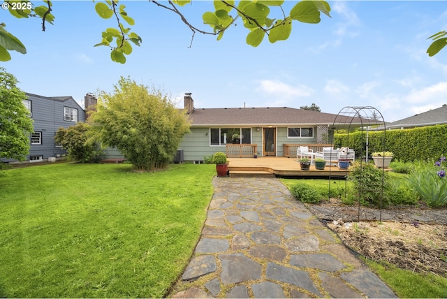 3132 SE 58th Ave, Portland, OR 97206 - rear view of property with a yard, a wooden deck, and a chimney