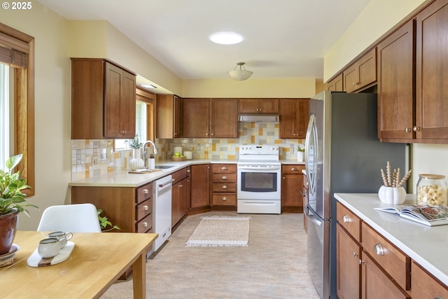 3132 SE 58th Ave, Portland, OR 97206 - kitchen featuring white appliances, decorative backsplash, light countertops, and brown cabinetry