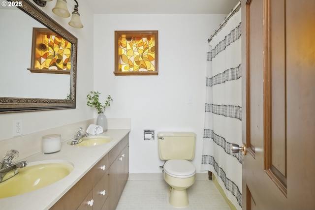 10776 SE Idleman Rd, Happy Valley, OR 97086 - full bathroom featuring double vanity, toilet, tile patterned floors, baseboards, and a shower with curtain