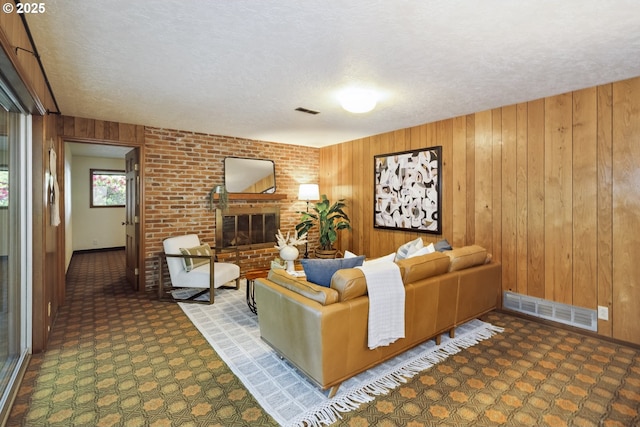 10776 SE Idleman Rd, Happy Valley, OR 97086 - carpeted living room featuring a textured ceiling, wooden walls, a fireplace, and baseboards