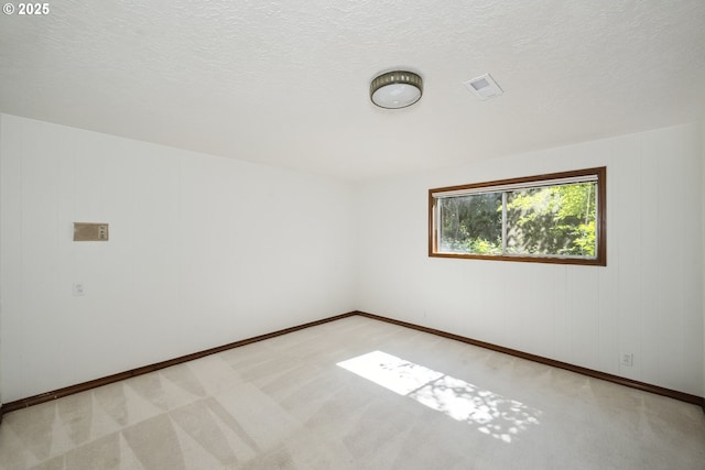 10776 SE Idleman Rd, Happy Valley, OR 97086 - spare room with baseboards, light colored carpet, and a textured ceiling