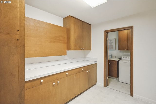 10776 SE Idleman Rd, Happy Valley, OR 97086 - kitchen featuring washer / clothes dryer, light countertops, brown cabinets, and light floors