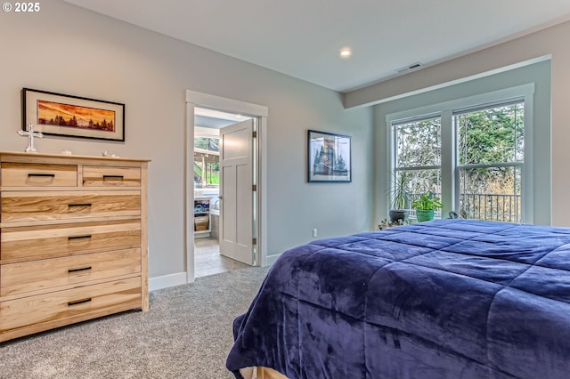 carpeted bedroom with visible vents and baseboards