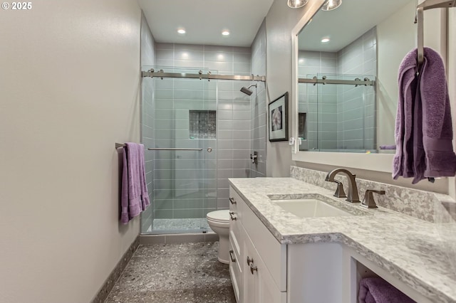 bathroom featuring a stall shower, recessed lighting, toilet, baseboards, and vanity