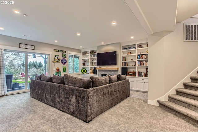 living room featuring light colored carpet, stairs, visible vents, and recessed lighting